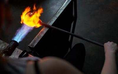 torching fire over glass that's molten